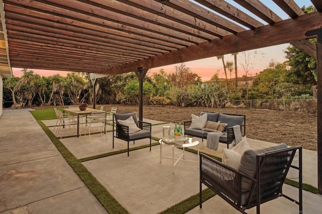 patio terrace at dusk featuring a pergola and outdoor lounge area