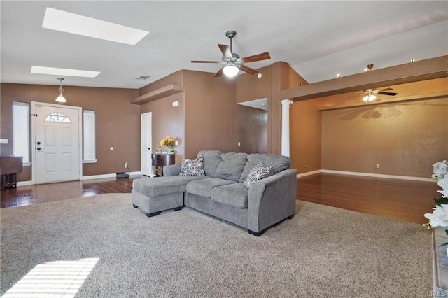 living room with ceiling fan, wood-type flooring, and lofted ceiling