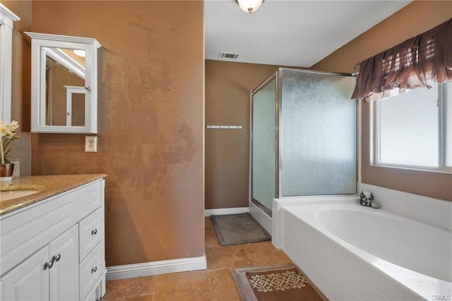 bathroom featuring vanity and independent shower and bath