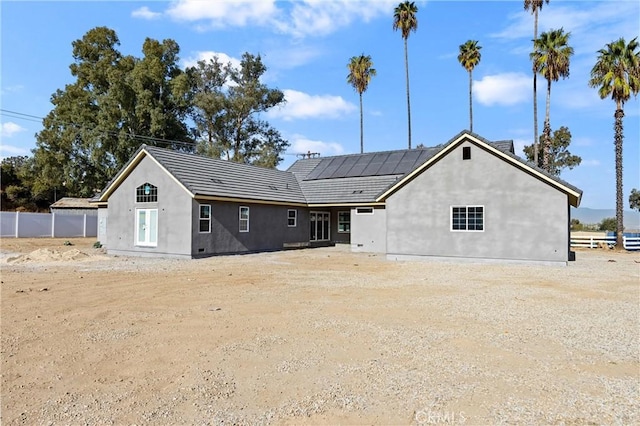 back of house with solar panels