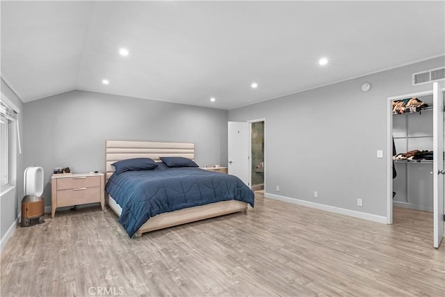 bedroom with light wood-type flooring and lofted ceiling