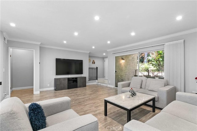 living room featuring crown molding and light hardwood / wood-style flooring