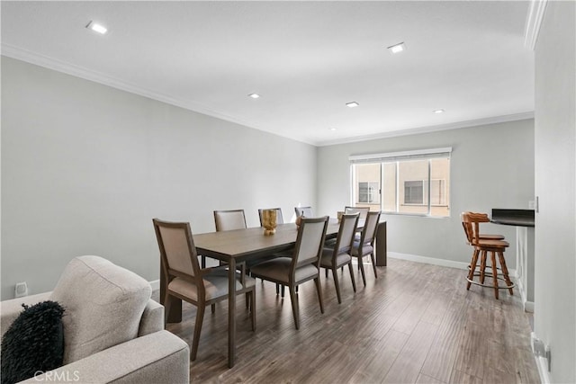 dining room featuring crown molding and dark wood-type flooring