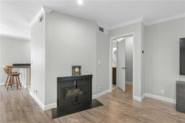 living room featuring light hardwood / wood-style floors and ornamental molding