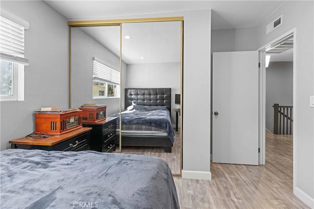 bedroom with hardwood / wood-style floors and a closet