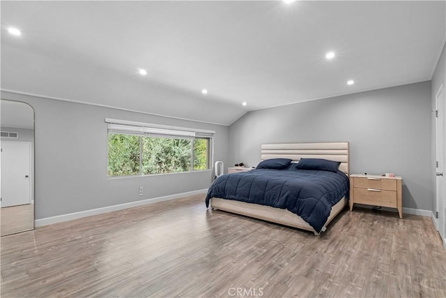 bedroom with light hardwood / wood-style flooring and vaulted ceiling