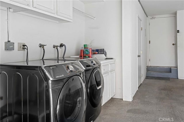 washroom featuring washer and dryer and cabinets