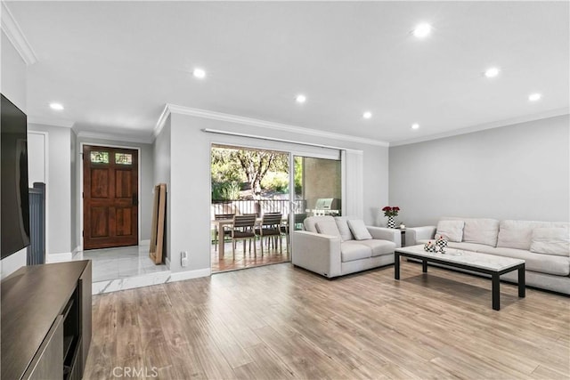 living room with light hardwood / wood-style floors and ornamental molding