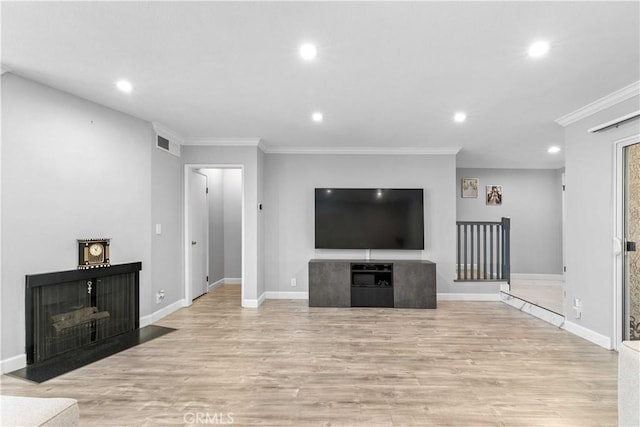 unfurnished living room with ornamental molding and light hardwood / wood-style flooring