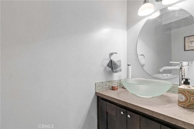 bathroom with vanity and decorative backsplash