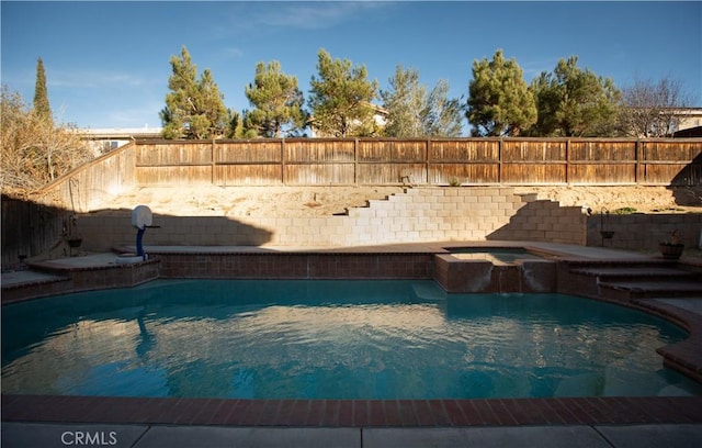 view of swimming pool with an in ground hot tub