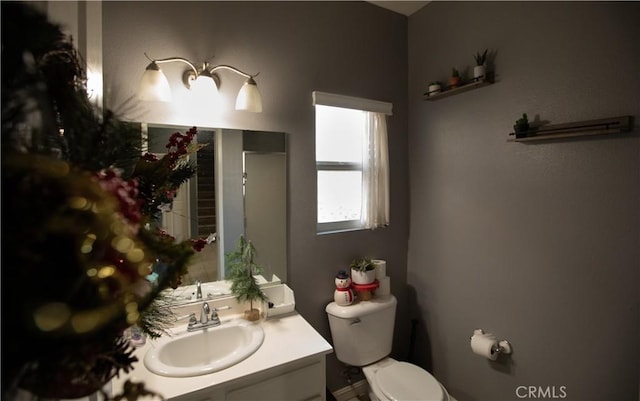 bathroom featuring vanity and toilet