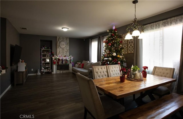 dining area with a notable chandelier and dark wood-type flooring