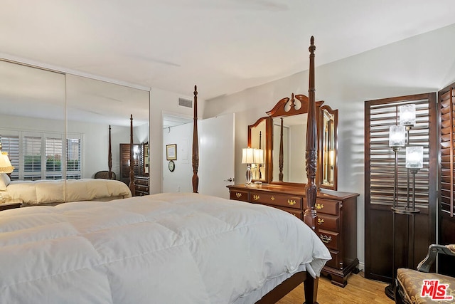 bedroom featuring light hardwood / wood-style flooring and a closet