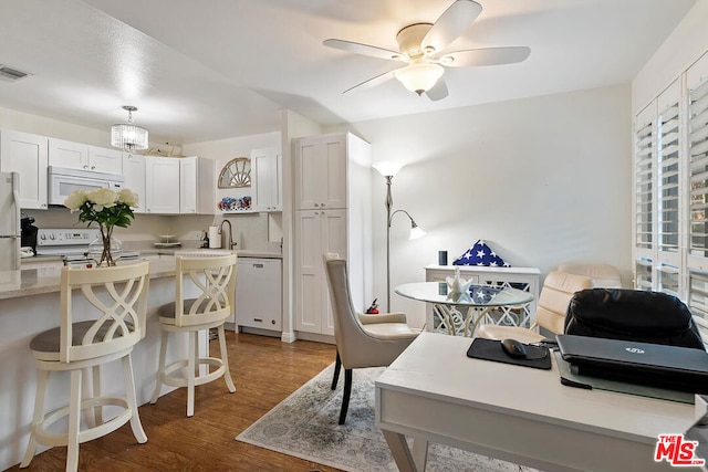 office area with ceiling fan, hardwood / wood-style floors, and sink