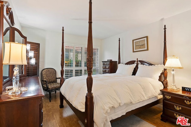 bedroom with dark hardwood / wood-style floors