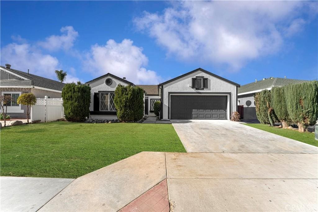 ranch-style home featuring a front yard and a garage