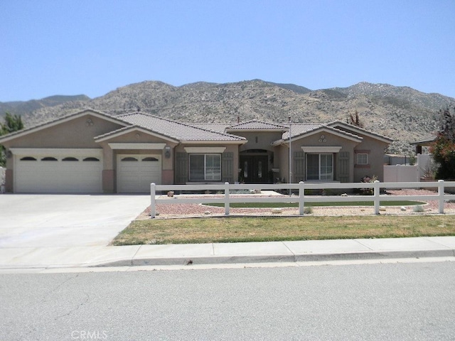 view of front facade with a mountain view and a garage