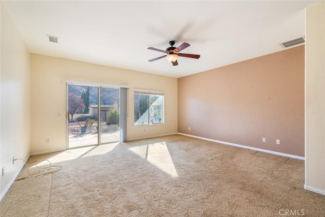 carpeted empty room featuring ceiling fan