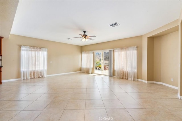 tiled spare room with ceiling fan and plenty of natural light