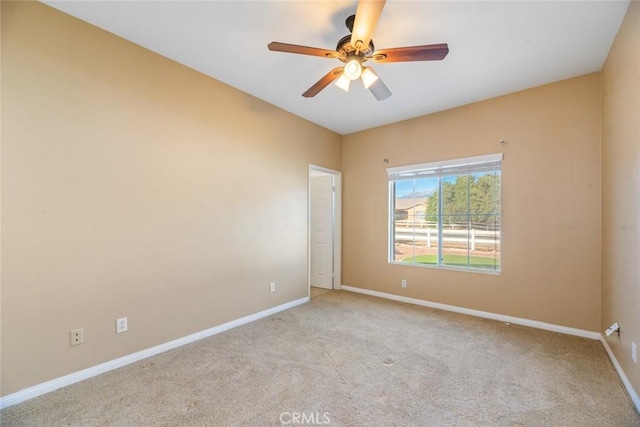 empty room featuring ceiling fan and light carpet