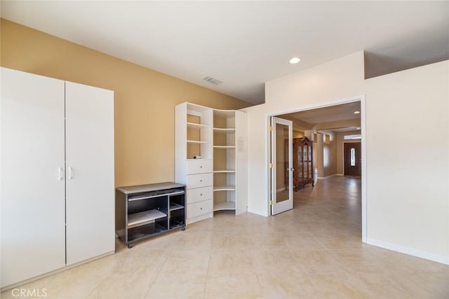 interior space featuring light tile patterned floors and french doors