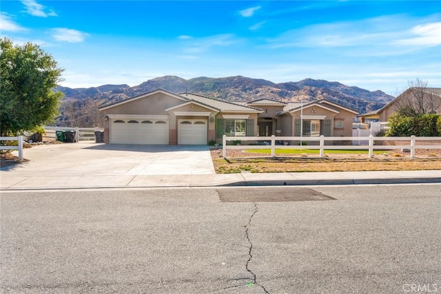 ranch-style house with a mountain view and a garage