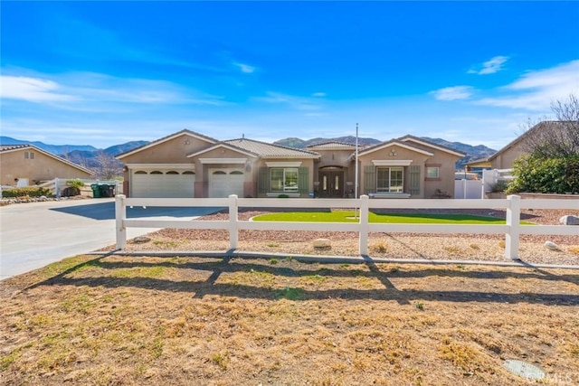 ranch-style home featuring a mountain view and a garage