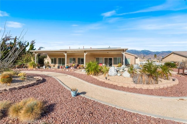 rear view of house featuring a mountain view