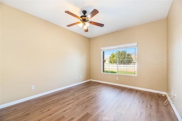 spare room featuring ceiling fan and light hardwood / wood-style flooring