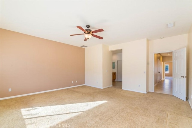 unfurnished room with ceiling fan and light colored carpet