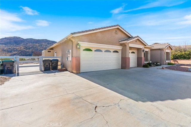 view of front of property featuring a mountain view and a garage