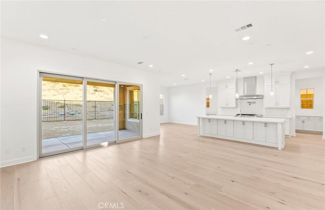 21235 Wildflower Way, Chatsworth, CA 91311 - unfurnished living room with light wood-style floors and recessed lighting
