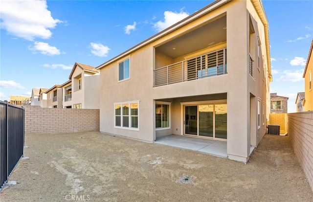 21235 Wildflower Way, Chatsworth, CA 91311 - back of property with stucco siding, a patio area, and a fenced backyard