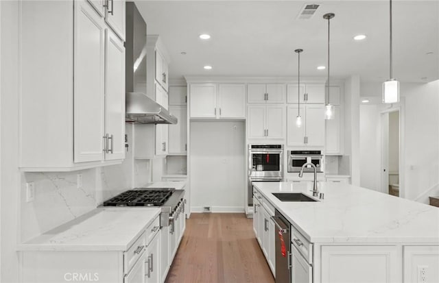 21235 Wildflower Way, Chatsworth, CA 91311 - kitchen with appliances with stainless steel finishes, white cabinets, recessed lighting, tasteful backsplash, and wall chimney exhaust hood