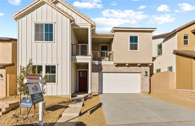 21235 Wildflower Way, Chatsworth, CA 91311 - view of front facade featuring board and batten siding, a balcony, concrete driveway, and a garage