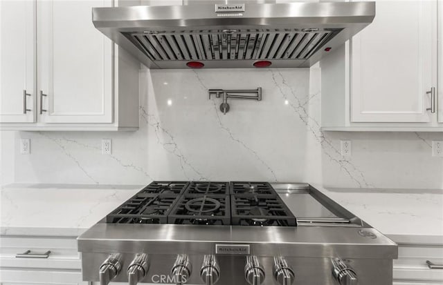 21235 Wildflower Way, Chatsworth, CA 91311 - kitchen with exhaust hood, decorative backsplash, white cabinetry, and light stone countertops