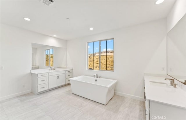 21235 Wildflower Way, Chatsworth, CA 91311 - bathroom featuring two vanities, a soaking tub, healthy amount of natural light, and recessed lighting