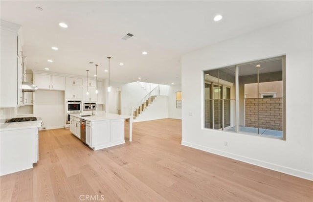 21235 Wildflower Way, Chatsworth, CA 91311 - kitchen featuring open floor plan, white cabinets, recessed lighting, light wood finished floors, and light countertops