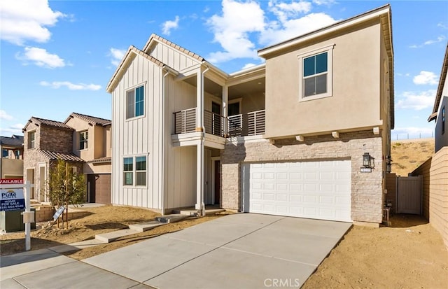 21235 Wildflower Way, Chatsworth, CA 91311 - view of front of house featuring a balcony, a garage, driveway, and board and batten siding