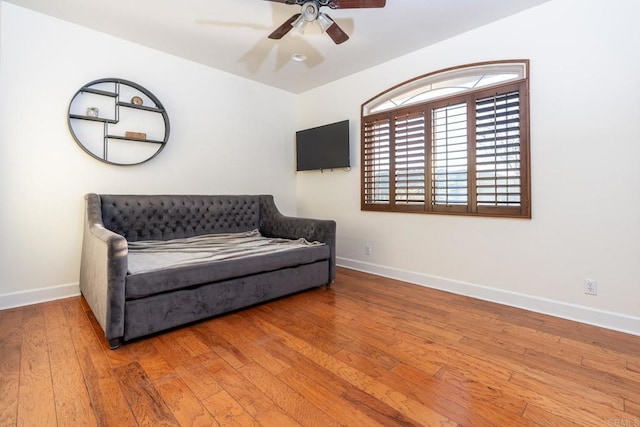 living area with ceiling fan and wood-type flooring