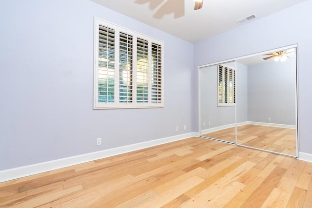 unfurnished bedroom with multiple windows, a closet, and ceiling fan