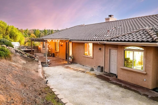 back house at dusk with a patio