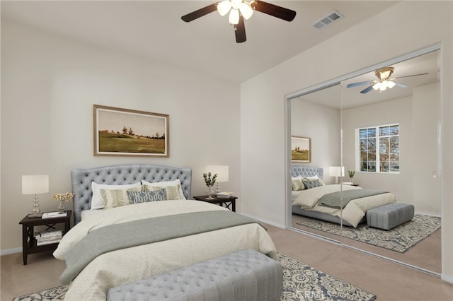 carpeted bedroom featuring ceiling fan and a closet