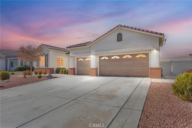 mediterranean / spanish house with a garage