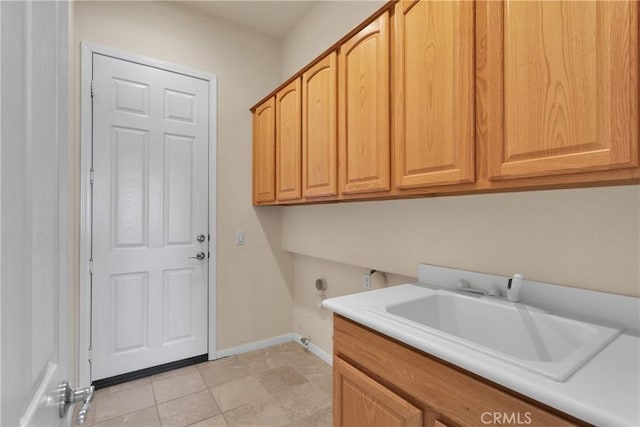 laundry room featuring sink, light tile patterned floors, cabinets, and hookup for an electric dryer