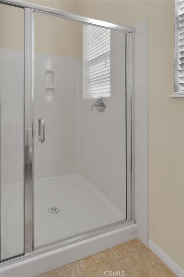 bathroom featuring tile patterned floors and an enclosed shower