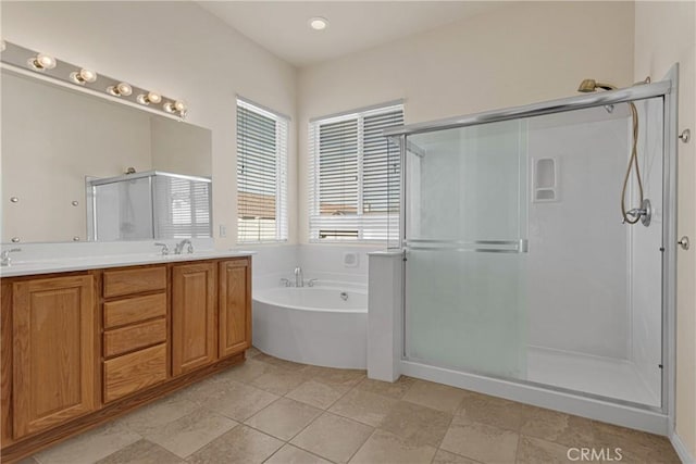 bathroom featuring vanity and independent shower and bath