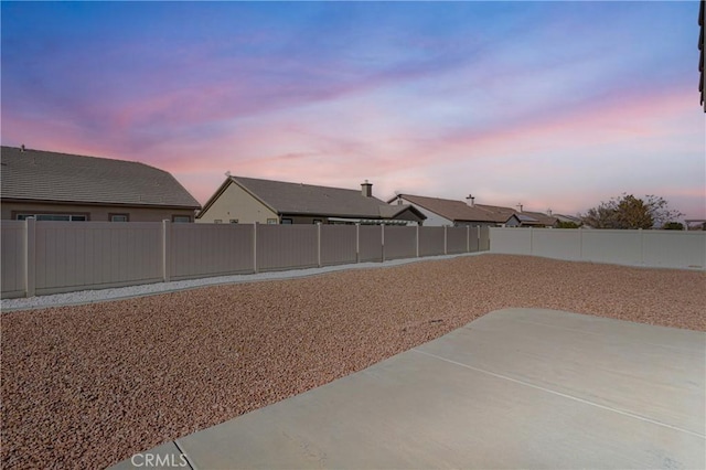 yard at dusk with a patio area