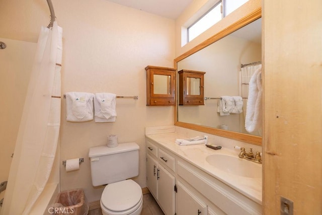 bathroom featuring vanity, curtained shower, and toilet